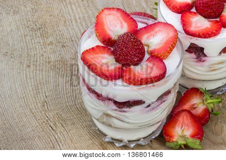 Tasty dessert with cream and fresh strawberries