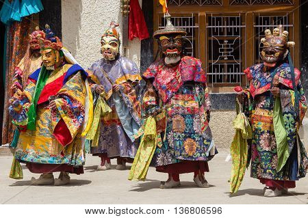 LAMAYURU INDIA - JUNE 13 2015: Unidentified buddhist lamas dressed in mystical mask dancing Tsam mystery dance in time of Yuru Kabgyat Buddhist festival at Lamayuru Gompa Ladakh North India