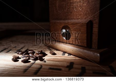 Roasted coffee beans and brown rustic mill
