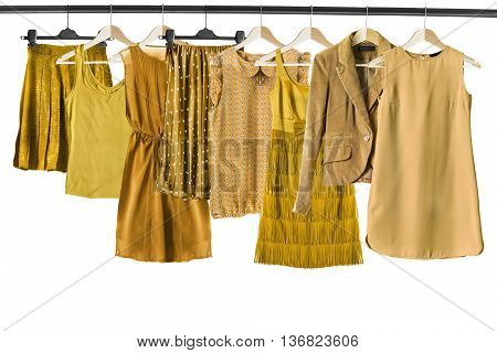 Set of yellow clothes on clothes racks isolated over white