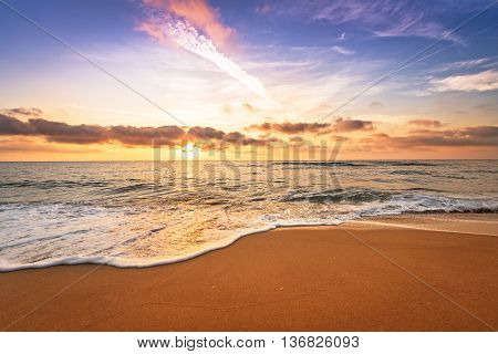 Sunrise on the beach. Golden beach and blue sky.