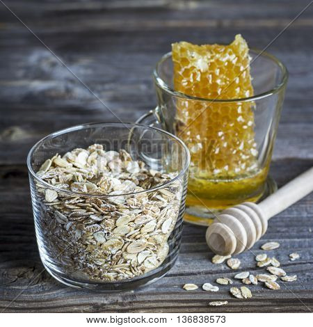 Ingredients for breakfast cereals, milk honeycomb on a dark wooden background