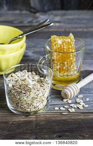 Ingredients for breakfast cereals, milk honeycomb on a dark wooden background