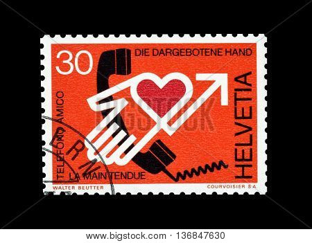 SWITZERLAND - CIRCA 1975 : Cancelled postage stamp printed by Switzerland, that shows The proffered hand.