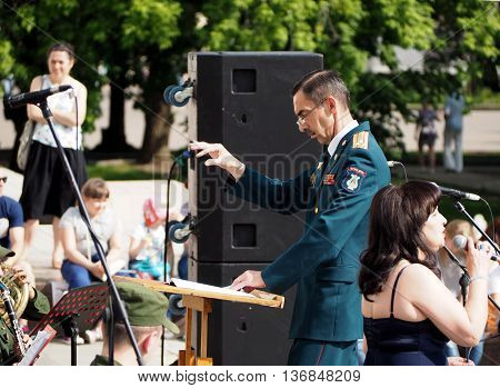 MOSCOW, RUSSIA - May 28, 2016: Band-master and singer during a performance on the Central Avenue in the Park of VDNH Moscow. International Military Music Festival 