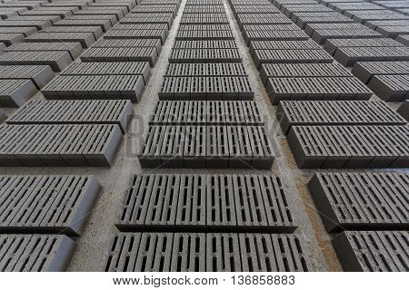 Stack of bricks. Manufacturing of aerated concrete blocks. Manufacturing of cinder block. The plant manufactures building material. The plant produces a cinder block. Cinder block-building material.