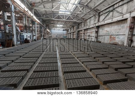 Stack of bricks. Manufacturing of aerated concrete blocks. Manufacturing of cinder block. The plant manufactures building material. The plant produces a cinder block. Cinder block-building material.
