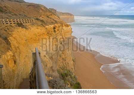Partial view of 86 step wooden staircase beach access at Gibson Steps down the cliff to the seashore in Port Campbell National Park on the Great Ocean Road in Victoria, Australia