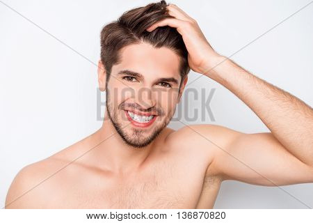 Portrait Of Happy  Healthy Man Combing His Hair With Fingers