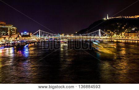 Cruise Boats Danube River Passing Under Chain Bridge Night Budapest Hungary. Elizabeth Bridge in the distance