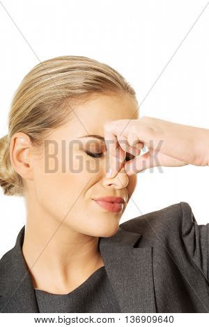 Woman pinching nose because of smell