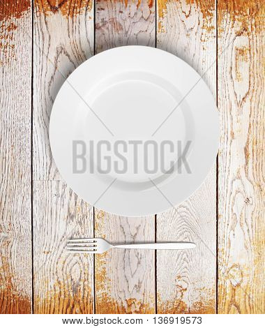 Top view of empty plate and fork on aged wooden table. Mock up 3D Rendering