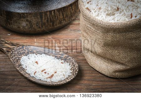 Rice in small sack on dark wooden table