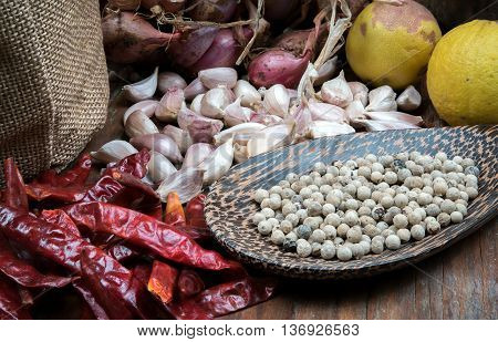 Spices many with Pepper in ladle on dark wooden table