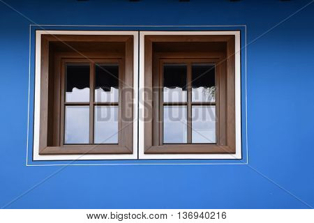 Windows on a blue facade of a Bulgarian traditional house