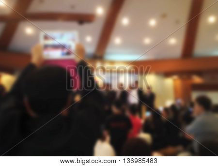 Blurred Background Of Man Recording Video Or Taking Picture By Smartphone