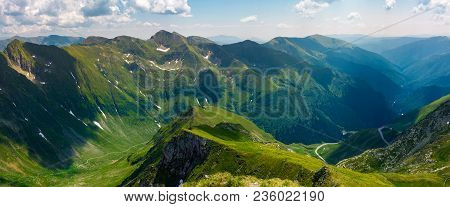 Panorama Of Fagarasan Mountain Ridge In Summertime. Lovely Landscape With Cliffs And Grassy Hills Ov