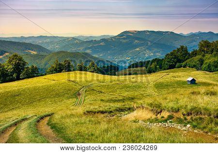 Truck Path Down The Grassy Hill. Wooden Shed On The Hillside. Beautiful Landscape With Krasna Mounta