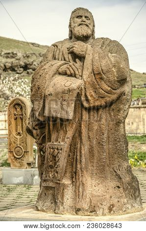 Oshakan,armenia,19 Februar,2018: Stone Sculpture To The Founder Of The Armenian Alphabet And The Fir