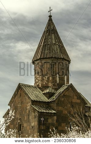 The Dome Of The Church Of St.marine Against The Cloudy Sky Among Flowering Apricot Trees In The City