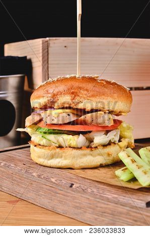 Top View Fresh Homemade Burger With Chicken, Salad, Cheese, Onion, Cucumber, Tomato, Sause And Dark 