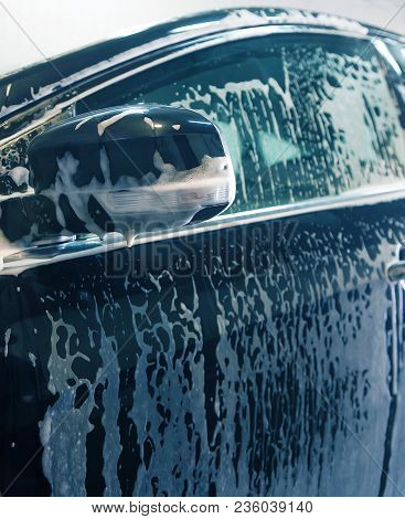 Car Covered With Foam On Car Wash