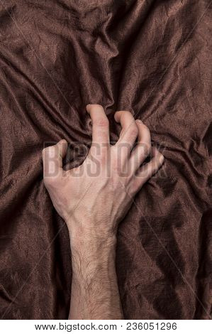 Man's Hand Holding A Satin Sheet, A Moment Of Pleasure