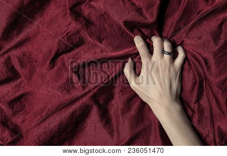 Woman's Hand Holding A Satin Sheet, A Moment Of Pleasure
