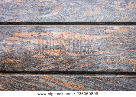 Decorative Facing, Made Of A Gray Polished Stone Plates With A Natural Fancy Ornament Like A Randoml