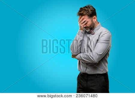 Middle age man, with beard and bow tie stressful keeping hands on head, tired and frustrated