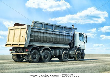 Big Dump Truck Goes On Highway Clouse Up Photo