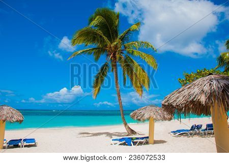 Holguin, Cuba, Playa Esmeralda. Beautiful Caribbean Sea Turquoise Blue Color And Palm Trees On The B