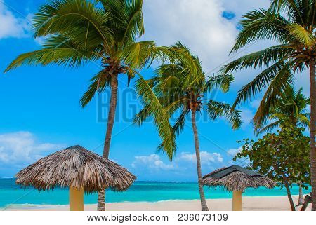 Playa Esmeralda In Holguin, Cuba. Caribbean Sea. Beautiful Paradise Beach: Umbrellas, Sea, Palm Tree