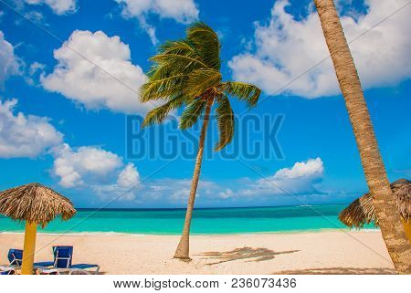 Holguin, Cuba, Playa Esmeralda. Beautiful Caribbean Sea Turquoise Blue Color And Palm Trees On The B