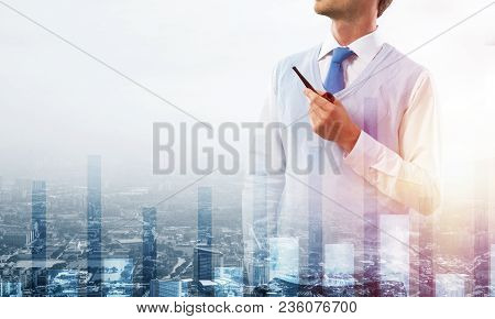 Double Exposure Of Confident And Young Businessman In Smart-casual Wear Smoking Pipe And Modern City