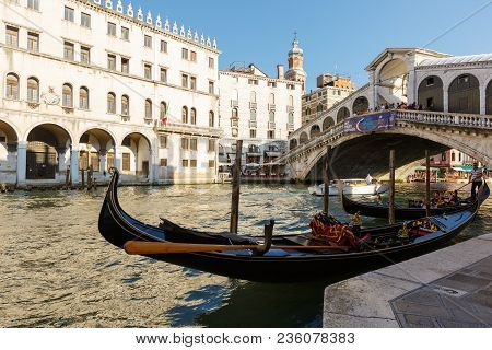 Venice, Italy - June, 21, 2013: View Of Gondola And Ponte Di Rialto, Many Tourists On A Bridge, Moto