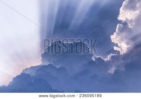 Sun Light Beams Escaping Behiind Large White Puffy Clouds In Vietnam In Southeast Asia.