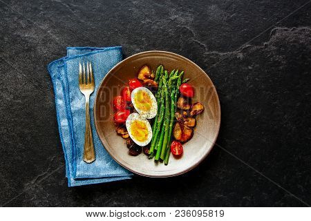 Flat-lay Of Healthy Vegetarian Breakfast Plate. Aspargus, Tomatoes, Mushrooms And Eggs Over Black St