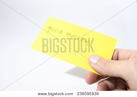 Good Evening Handwrite With A Hand On A Yellow Paper Compsoition