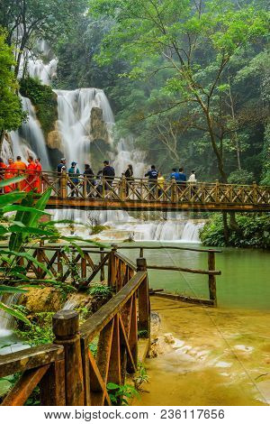 Luangprabang, Laos - December 8, 2015: Tourists On Wooden Bridge Sightseeing Kuang Si Waterfalls In 
