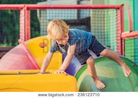 Adorable Little Toddler Boy Having Fun On Playground.