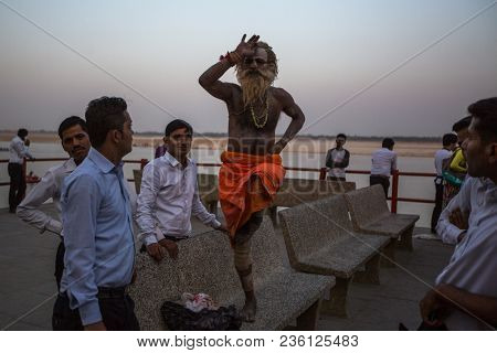 VARANASI, INDIA - MAR 26, 2018: Sadhu or Baba (holy man) on the ghats of Ganges river. Normally a sadhu is a monk, renounced, renounced material enjoyment. In India from 4 to 5 million sadhu.