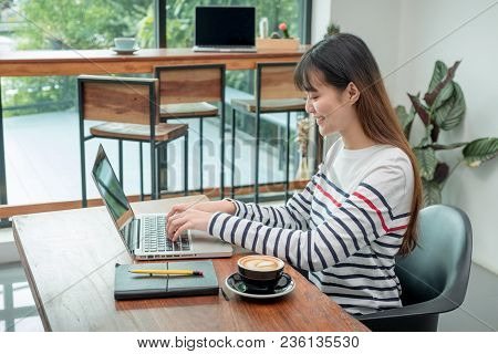 Happy Asian Woman Using On Laptop Computer While Working Near Window At Cafe Restaurant,digital Co W
