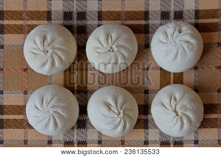 Manty On A Checkered Yellow-brown Tablecloth. Cooking. A National Dish