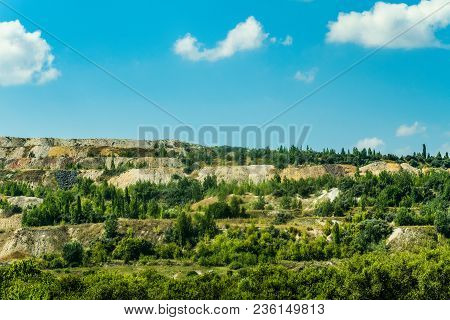 Dumps Of Processed Iron Ore With Growing Green Plants. Waste From The Iron Ore Industry. Belgorod Re