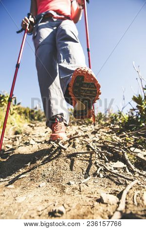 Photo of tourist human with sticks for sport walking