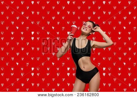 Frontview Of Fashion Pop Art Model Posing Wearing Pink Sunglasses. Girl Having Black Stylish Swimwea