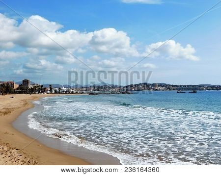 A View Of The Town And Marina Of Frejus, France, From The Beach