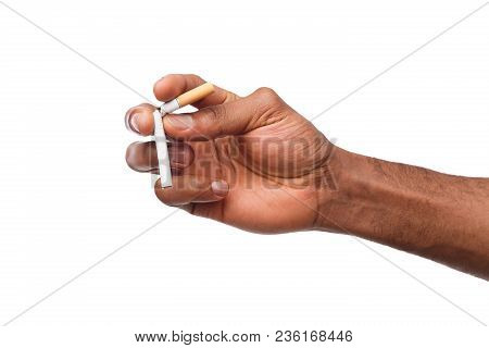 Black Male Hand Breaking A Cigarette, Isolated On A White Background. Bad Habit, Smoking Concept