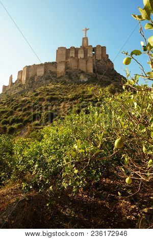 The Statue Of Jesus Christ On Top Of A Fortress On A Mountain In The City Of Monteagudo In Spain.